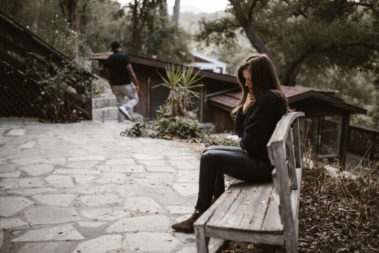 Woman on a bench reflecting during Breakup recovery