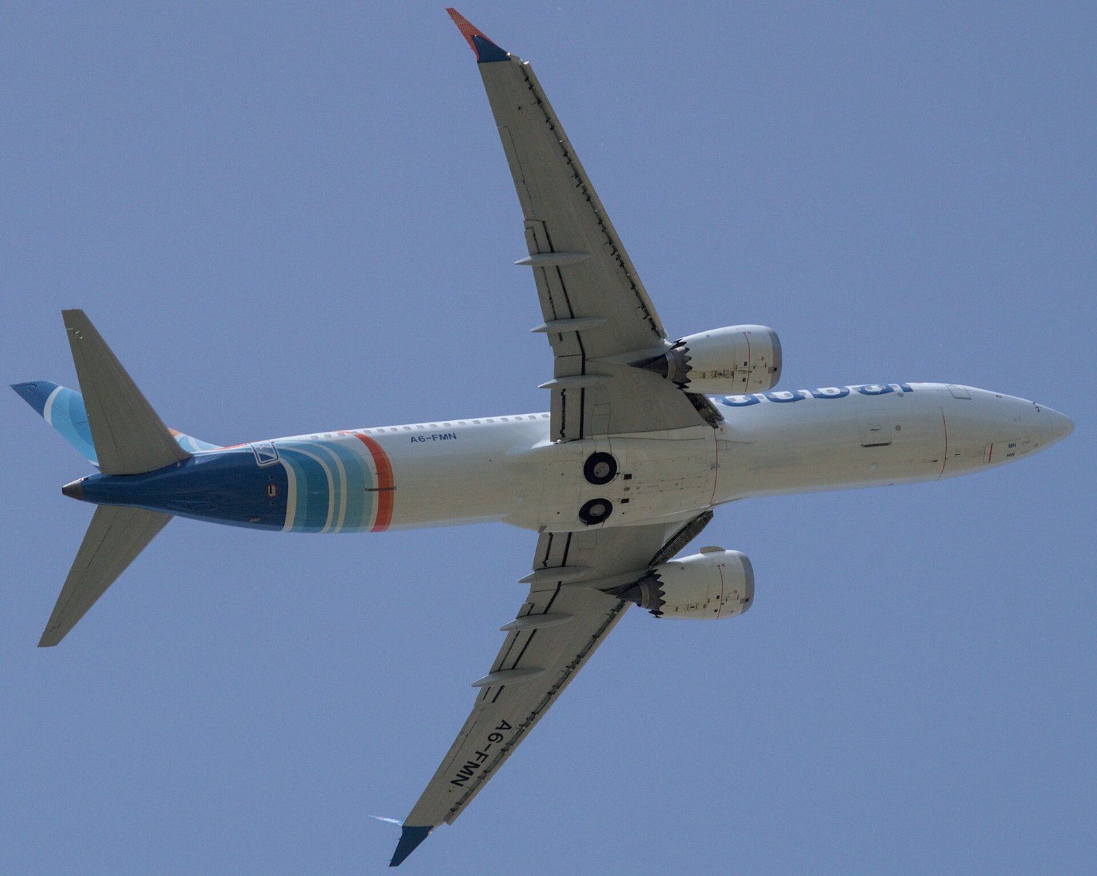 A Flydubai Boeing 737 MAX 8 climbs after takeoff from Pisa in 2024; the same model is at the center of the Flydubai investigation
