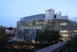 TV Asahi headquarters in Tokyo at dusk; the Glasses With a Chance of Delinquent anime airs on TV Asahi and ABC TV in April 2027