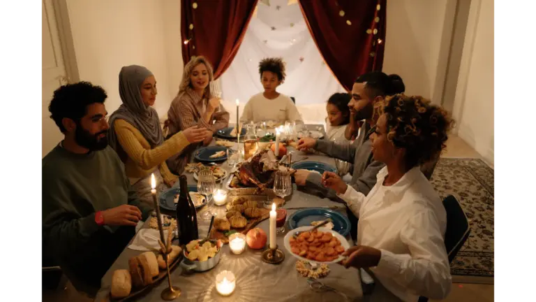 A happy family gathering around a candlelit table for a festive dinner, highlighting the importance of boundaries with family during holiday celebrations.