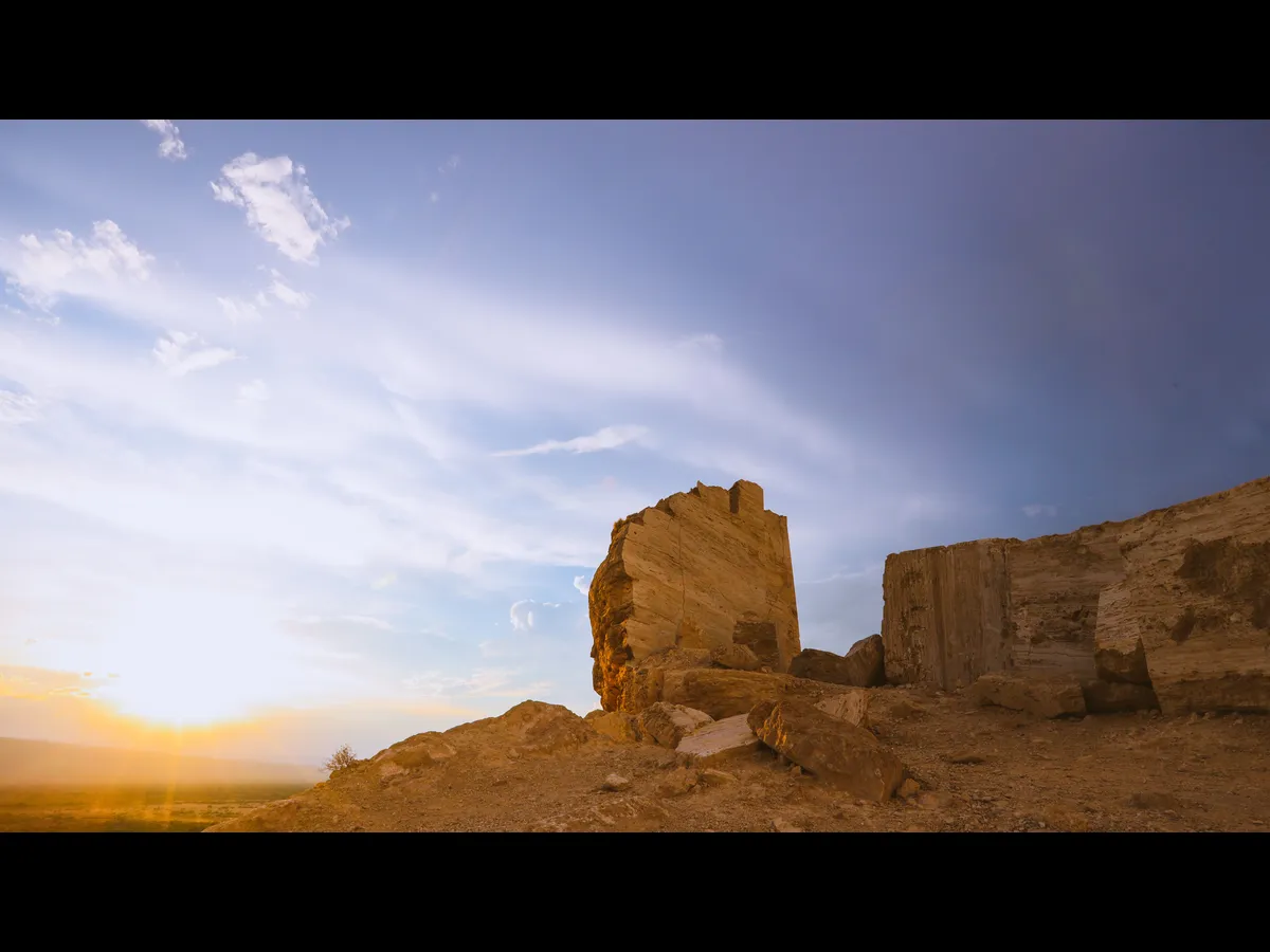 In Monday's daily devotional, broken walls of a city are depicted against a blue sky with clouds.