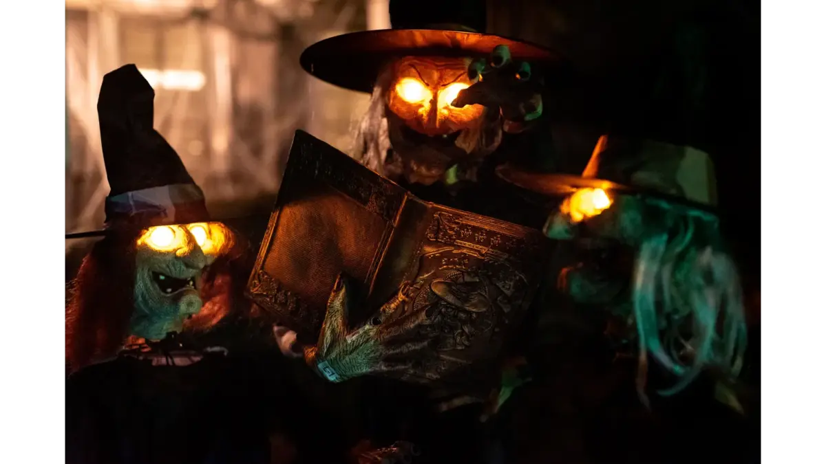 Halloween decorations featuring glowing witch figures and an eerie spellbook create the perfect backdrop for cozy, enchanting witchy Halloween decor.