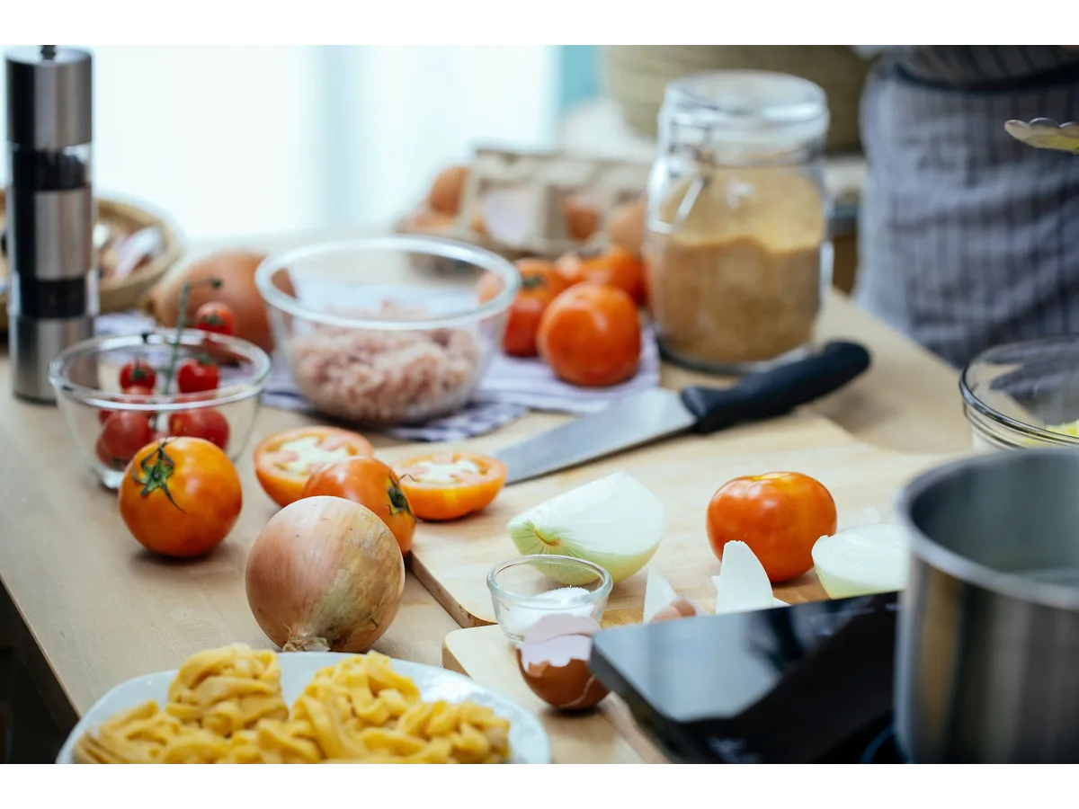 Fresh ingredients like tomatoes and onions for preparing an Italian meal at home, perfect for inspiring any 3-ingredient meal creation.