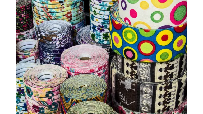 Colorful fabric rolls with diverse patterns on display, ideal for dollar crafting and design.
