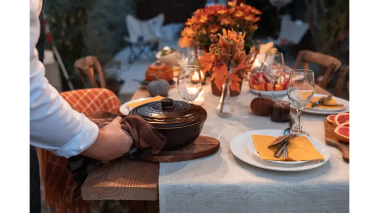 Beautifully arranged autumn table setting with festive decorations and a serving pot, showcasing how to avoid common Thanksgiving decorating mistakes while creating a warm and welcoming holiday display.