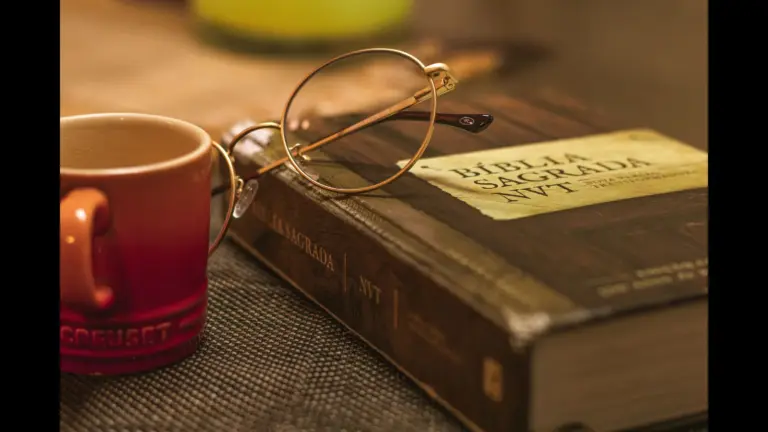 In Wednesday's daily devotional, a Bible sits on a desk with a pair of glasses and a coffee mug beside it.