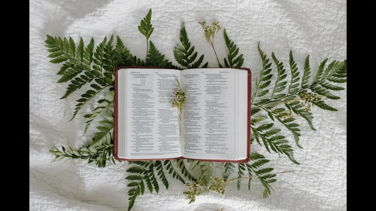 In Thursday's daily devotional, an open Bible sits atop palm branches on a white cloth.