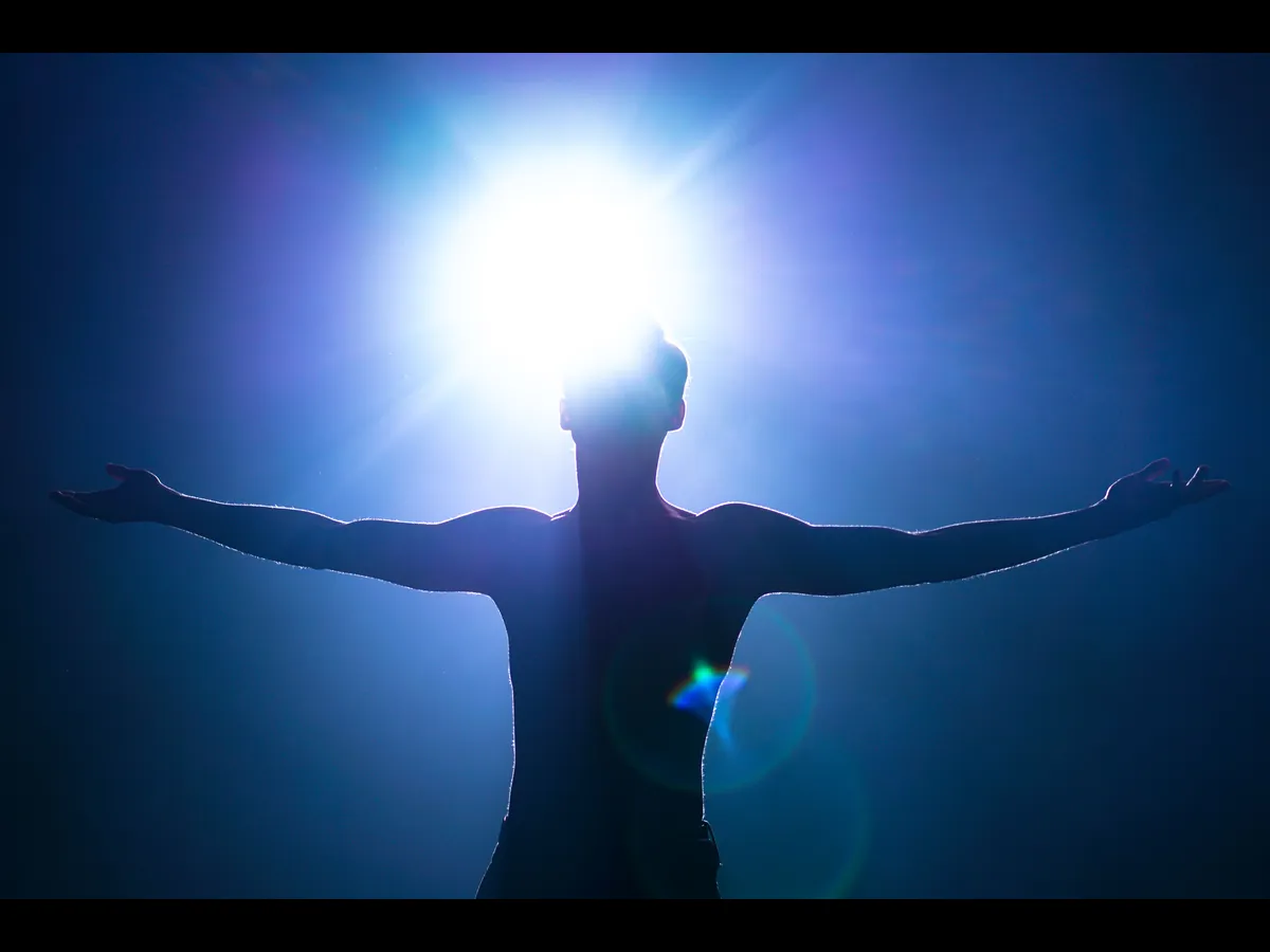 In Wednesday's daily devotional, a man's silhouette is seen as a bright light descends upon him in the darkness.