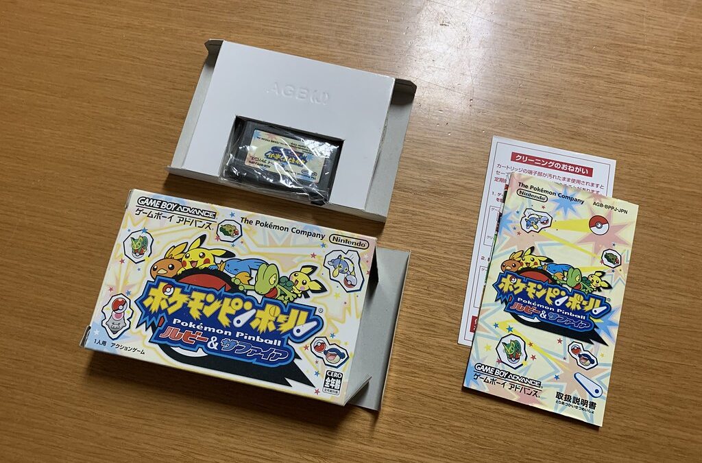 Pokémon Ruby and Sapphire Game Boy Advance games behind the Groudon Kyogre Rayquaza figures