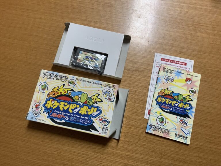 Pokémon Ruby and Sapphire Game Boy Advance games behind the Groudon Kyogre Rayquaza figures