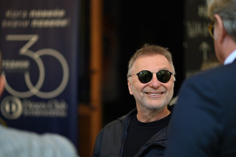 Director Milcho Manchevski, whose dark comedy Sister Brother Manhole Cover premieres at the 2026 Tokyo International Film Festival, smiles in sunglasses