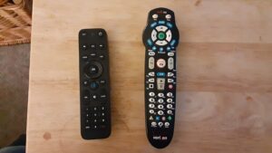 Two Verizon Fios TV remote controls on a wooden table, the service hit by the Starz Fios blackout