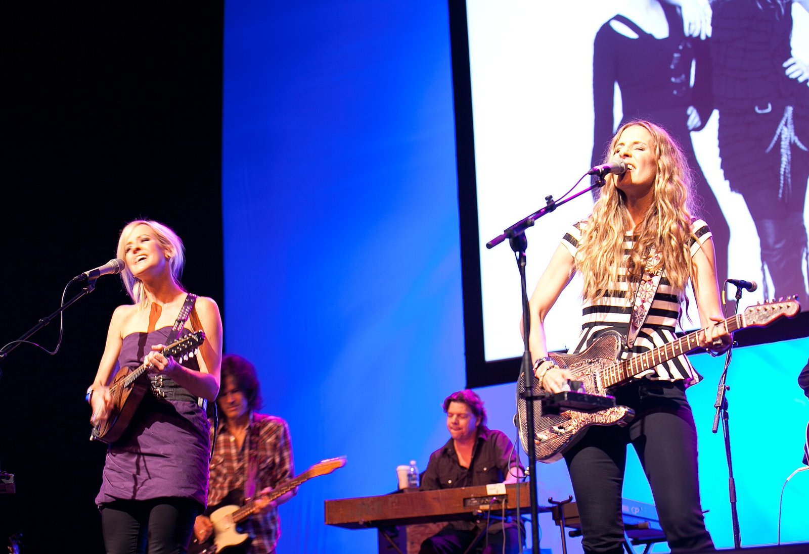 The Chicks tour history: Natalie Maines and Emily Strayer of the Chicks, then the Dixie Chicks, perform onstage with their band