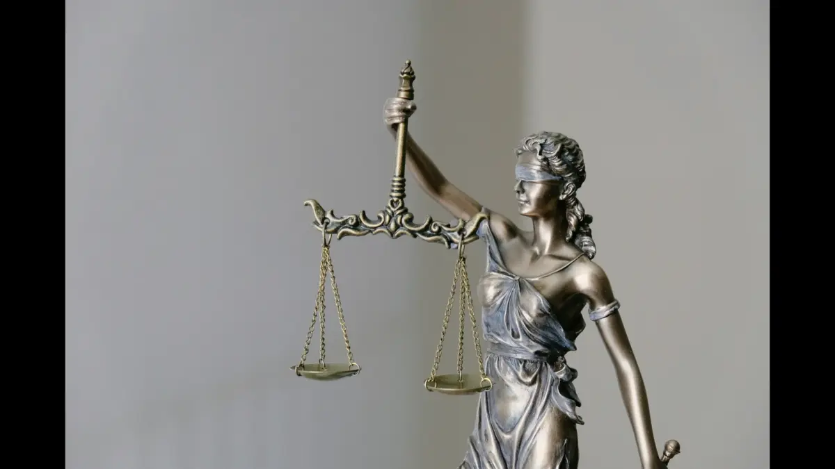 A bronze statue of Lady Justice, holding scales and wearing a blindfold. Caleb Flynn trial