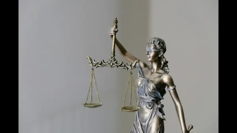 A bronze statue of Lady Justice, holding scales and wearing a blindfold. Caleb Flynn trial