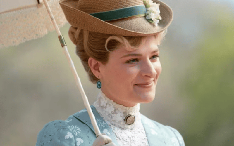 close-up of Marian, smiling, with a garden in the background
